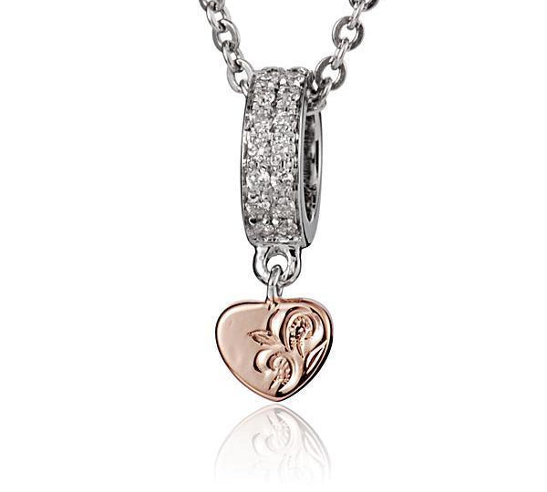 The picture shows a 14K white and rose gold two-tone pendant with hand engravings and diamonds.