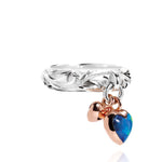 The picture shows a 14K rose gold and 925 sterling silver two-tone heart ring with hand engravings and opal.