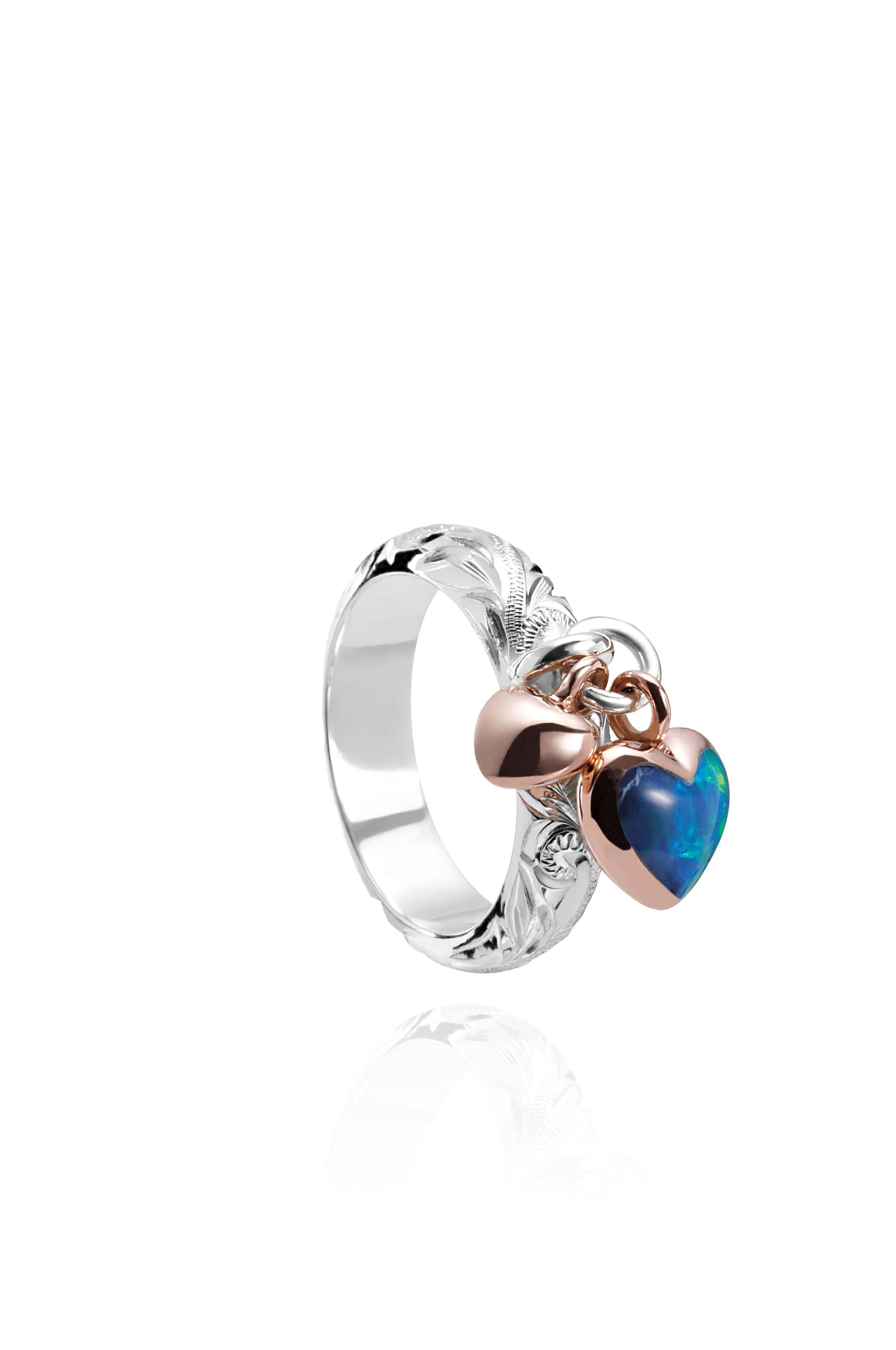 The picture shows a 14K rose gold and 925 sterling silver two-tone heart ring with hand engravings and opal.