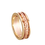 In this photo there is a yellow and rose gold two-tone ring with flower and scroll hand-engravings.