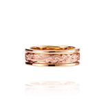 In this photo there is a yellow and rose gold two-tone ring with flower and scroll hand-engravings.