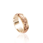 In this photo there is a rose and yellow gold two-tone ring with flower and scroll hand engravings.