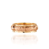 In this photo there is a rose and yellow gold two-tone ring with flower and scroll hand engravings.
