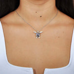 Abalone shell sterling silver sea turtle pendant worn by a model.