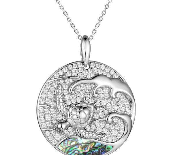 Sterling silver medallion pendant with a turtle swimming away from the abalone tides. 