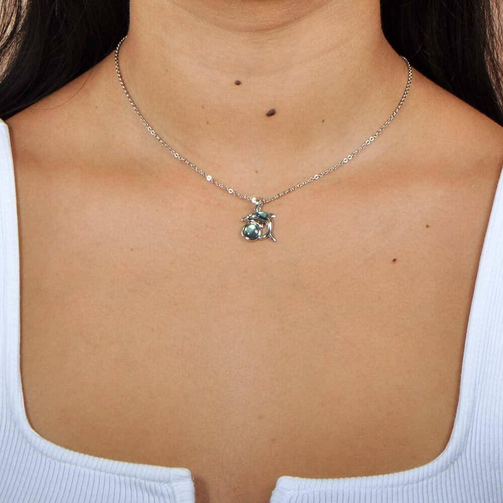 A model wearing a Stelling sliver and abalone pendant designed as a dolphin over circle. 
