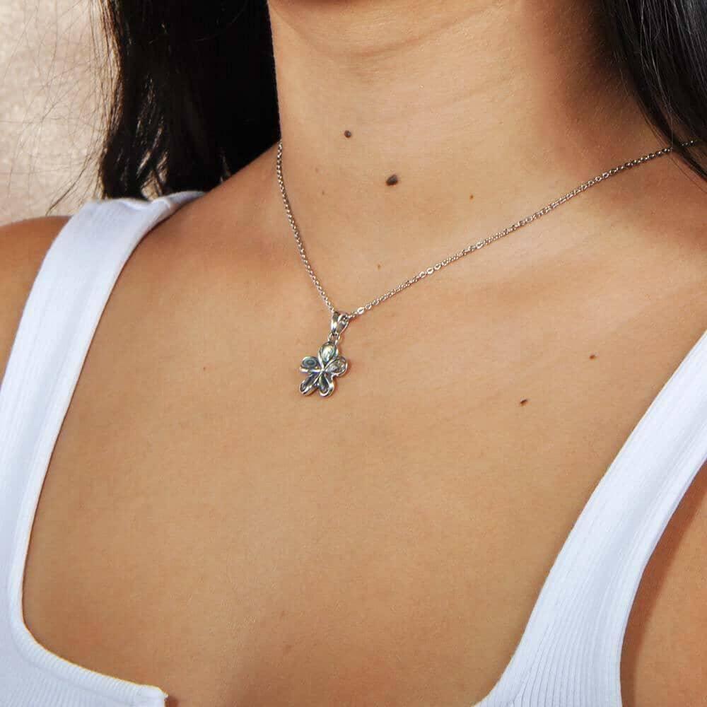 model wearing an Abalone and sterling silver plumeria shaped pendant. 
