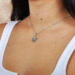 model wearing an Abalone and sterling silver plumeria shaped pendant. 