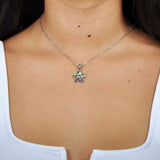 Abalone and sterling silver plumeria shaped pendant, worn by a model.