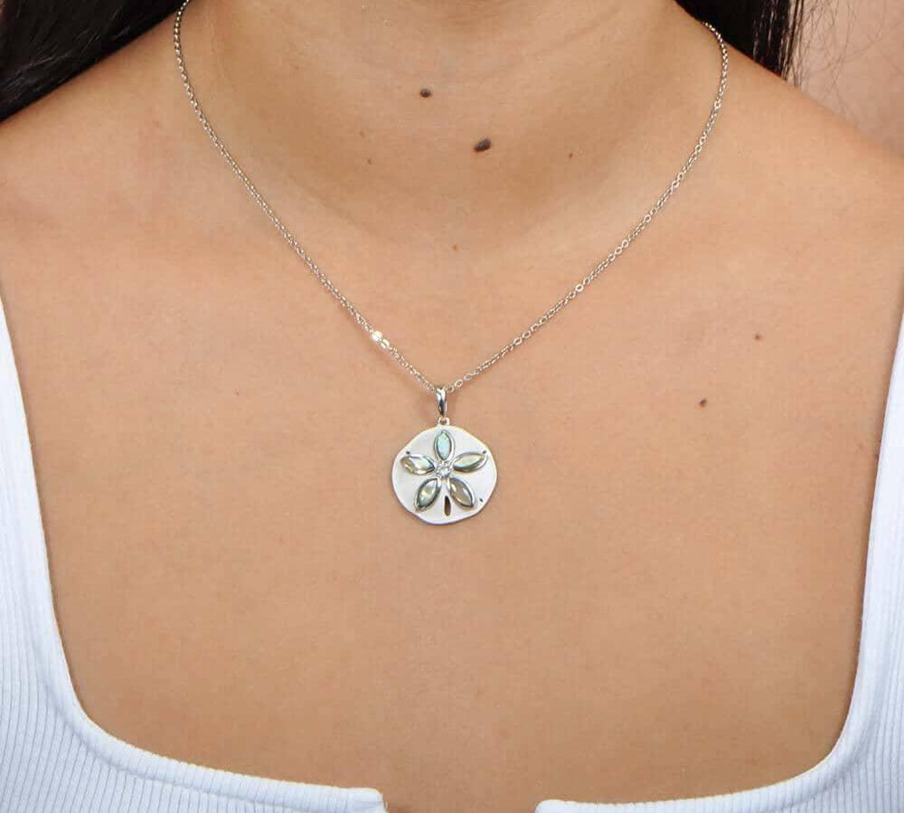 Sterling silver and Abalone Sand dollar pendant. The pendant is worn by a model.