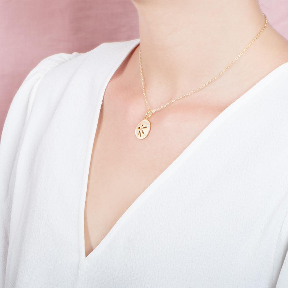 The picture shows a 925 sterling silver, yellow gold plated, sand dollar pendant with topaz.
