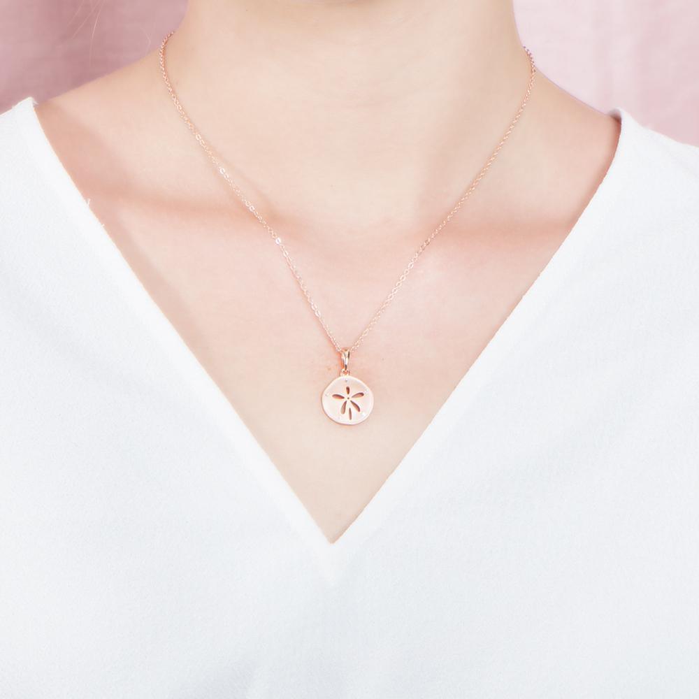 The picture shows a 925 sterling silver, rose gold plated, sand dollar pendant with topaz.
