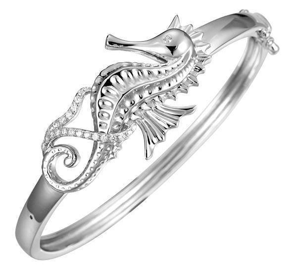 The picture shows a 925 sterling silver seahorse bangle with topaz.
