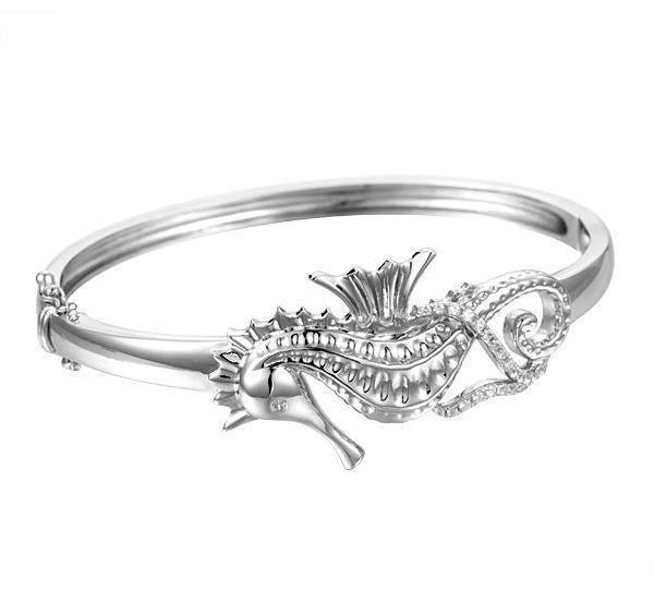 The picture shows a 925 sterling silver seahorse bangle with topaz.