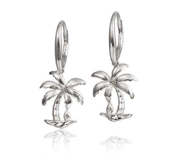 In this photo there is a pair of 925 sterling silver beachside palm tree lever-back earrings with topaz gemstones.