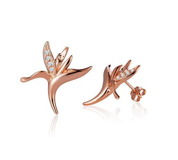 The picture shows a pair of 14K rose gold bird of paradise stud earrings paired with diamonds.