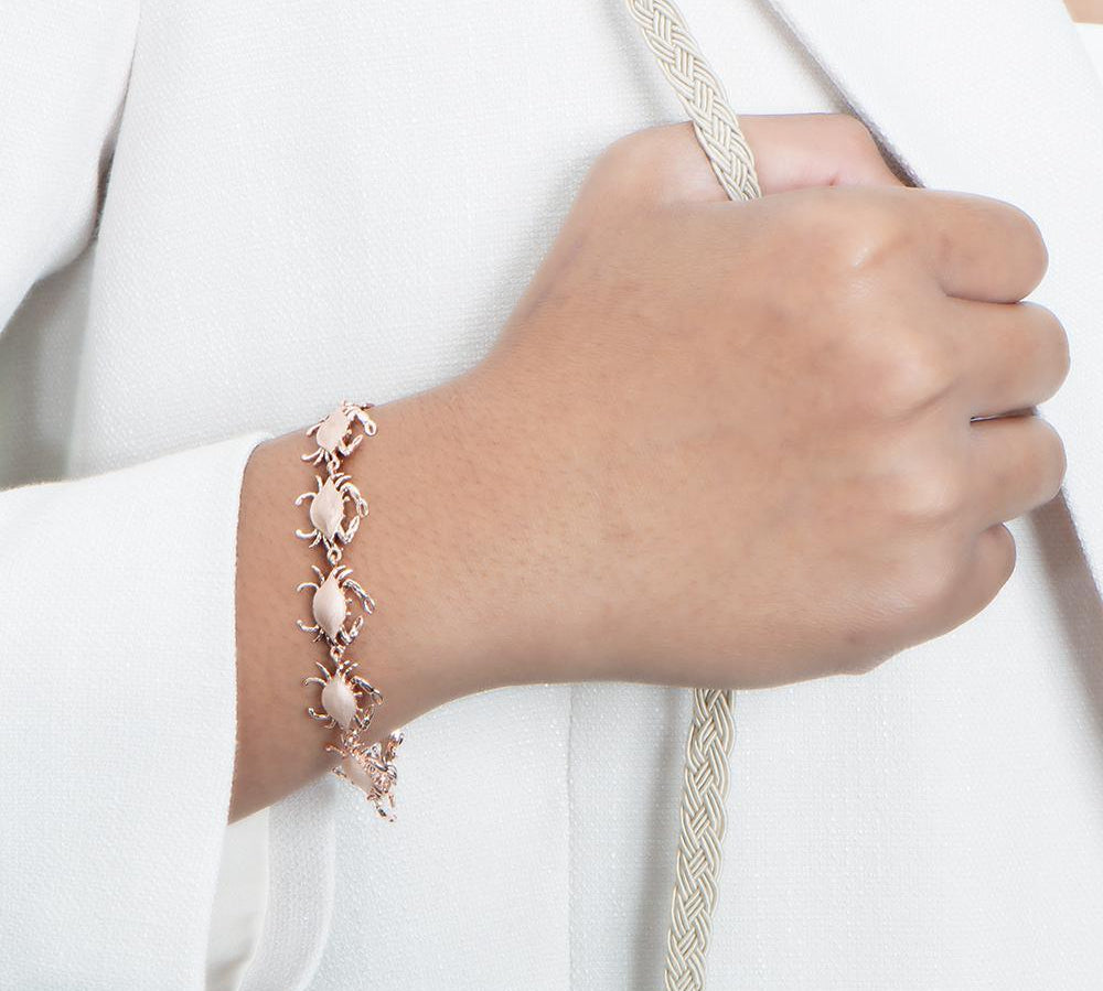 The picture shows a model wearing a 925 sterling silver white gold-plated blue crab bracelet.