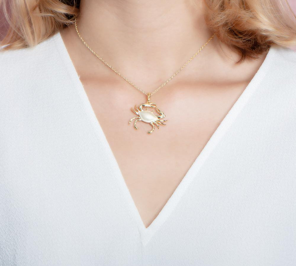 The picture shows a 925 sterling silver yellow gold plated crab pendant.