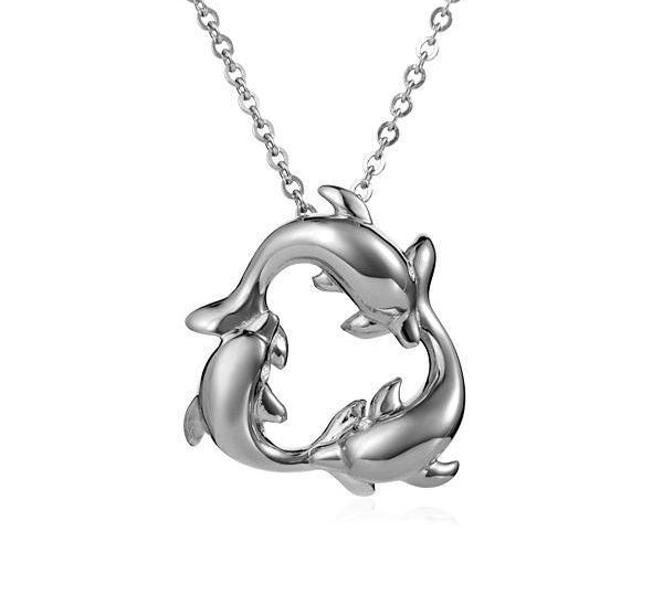 The picture shows a small pendant made of 14K white gold featuring a circle of dolphins.