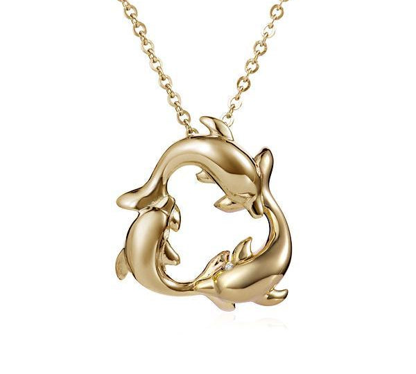 The picture shows a small pendant made of  14K yellow gold featuring a circle of dolphins.
