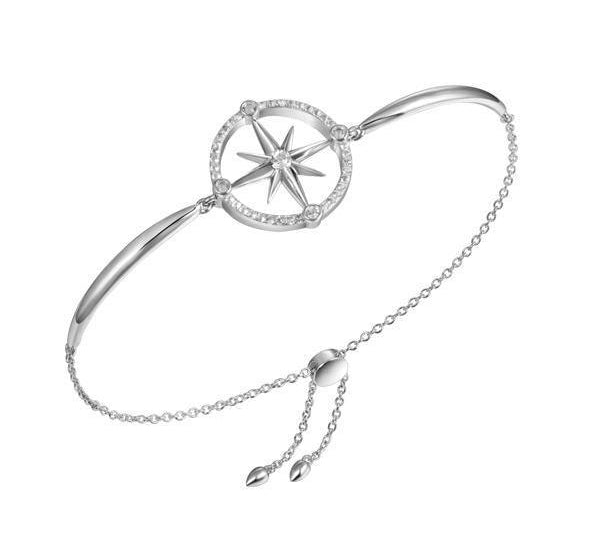 In this photo there is a sterling silver compass bracelet with topaz gemstones.