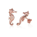 The picture shows a pair of 14K rose gold seahorse stud earrings with diamonds.