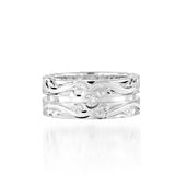 The picture shows a 925 sterling silver channel ring with hand engravings and diamonds.