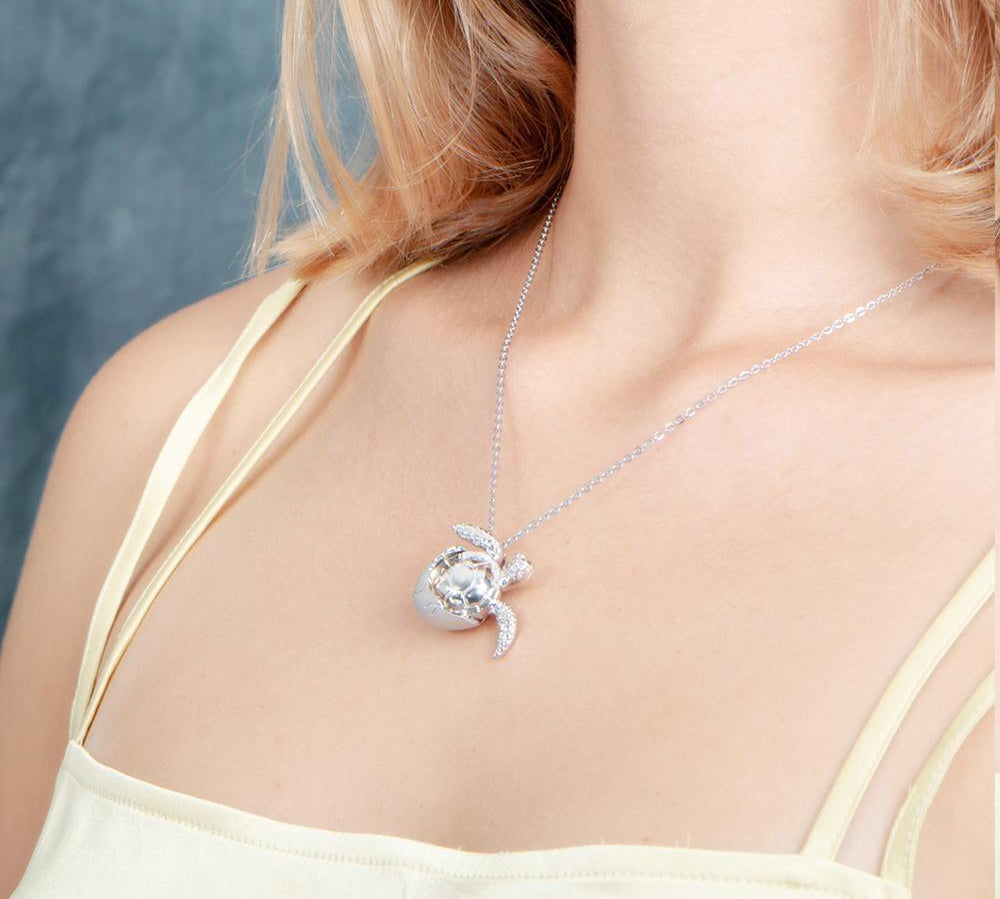 The picture shows a 925 sterling silver sea turtle hatchling pendant.