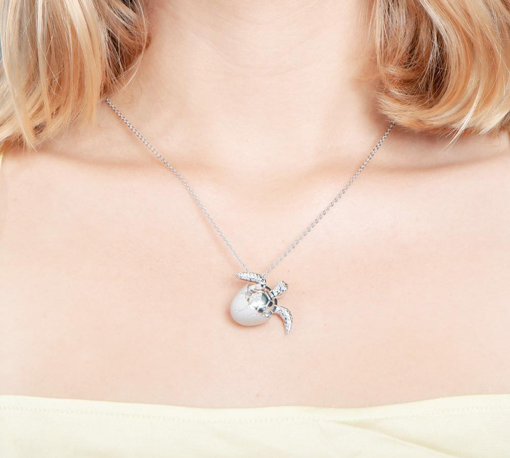The picture shows a 925 sterling silver sea turtle hatchling pendant.