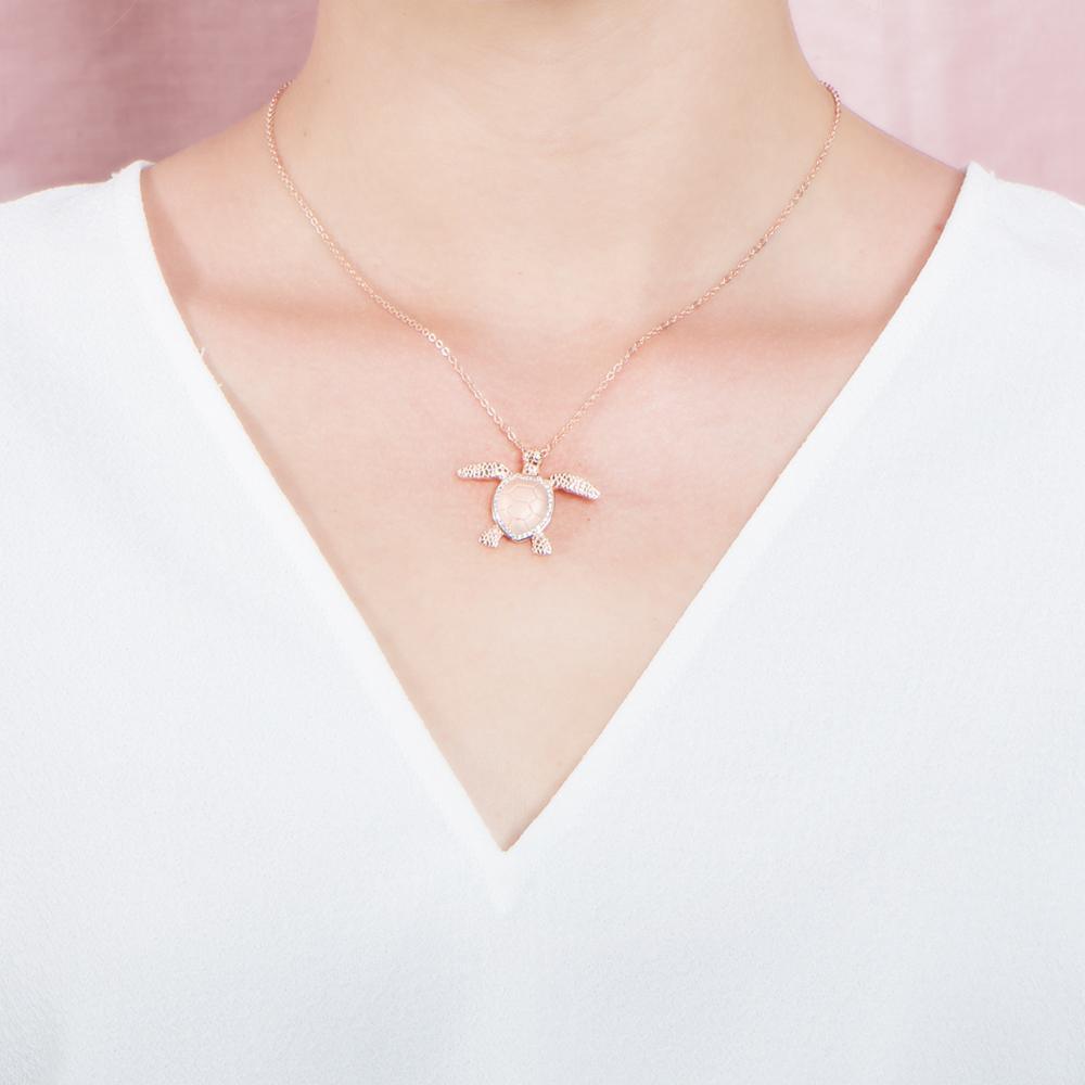 The picture shows a 925 sterling silver, rose gold plated, sea turtle pendant with topaz.