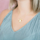 The picture shows a 925 sterling silver, yellow gold plated, sea turtle pendant with topaz.