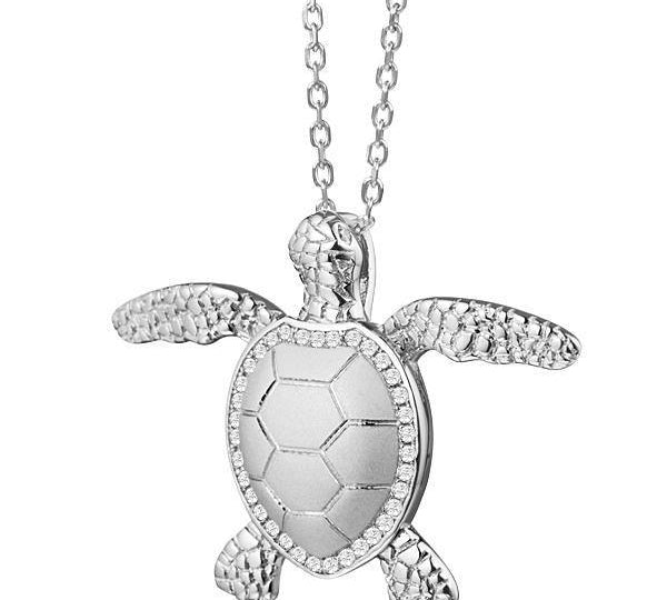The picture shows a 925 sterling silver, white gold plated, sea turtle pendant with topaz.