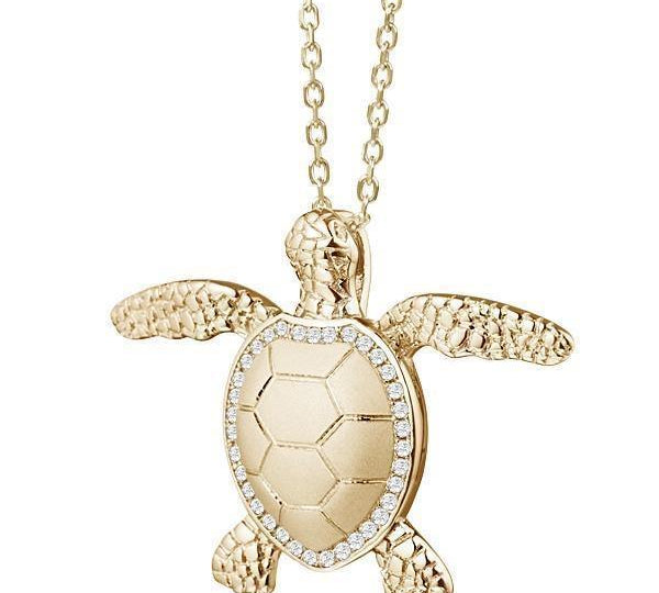 The picture shows a 925 sterling silver, yellow gold plated, sea turtle pendant with topaz.