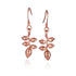 In this photo there is a pair of 14k rose gold heliconia flower hook earrings.