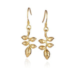 In this photo there is a pair of 14k yellow gold heliconia flower hook earrings.