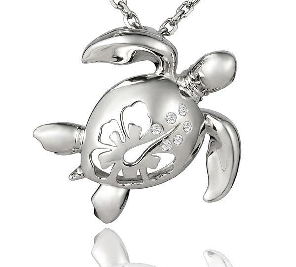 The picture shows a large 925 sterling silver sea turtle pendant with hibiscus cut-out and cubic zirconia.