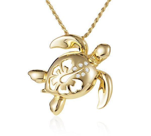 In this photo there is a yellow gold sea turtle pendant with a hibiscus flower cut-out and six diamonds.