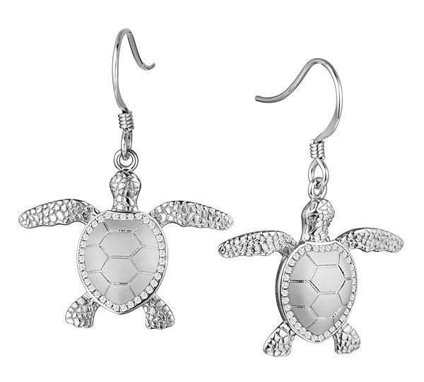 The picture shows a pair of 14K white gold sea turtle hook earrings with diamonds.