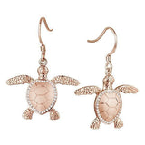 The picture shows a pair of 14K rose gold sea turtle hook earrings with diamonds.