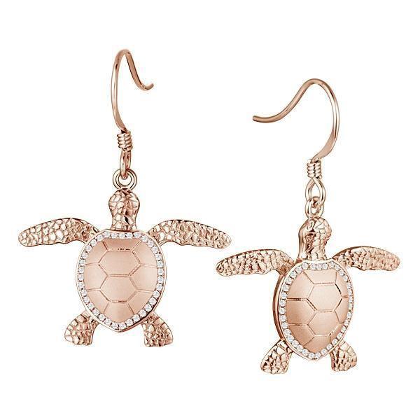 The picture shows a pair of 14K rose gold sea turtle hook earrings with diamonds.