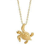 The picture shows a 14K yellow gold sea turtle necklace.