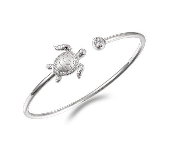 The picture shows a 925 sterling silver sea turtle bangle with topaz.
