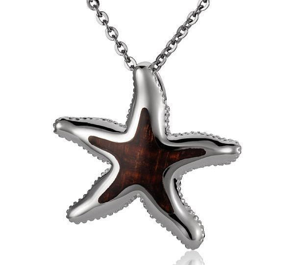 In this photo there is a sterling silver and koa wood starfish pendant.