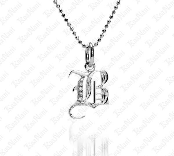 The picture shows a 14K white gold Koa Nani B initial pendant.