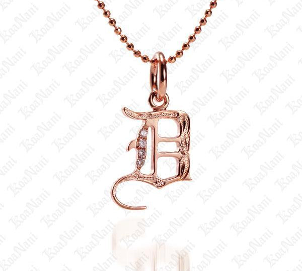 The picture shows a 14K rose gold Koa Nani D initial pendant.