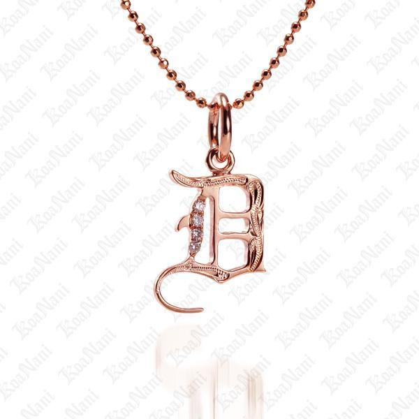 The picture shows a 14K rose gold Koa Nani D initial pendant.