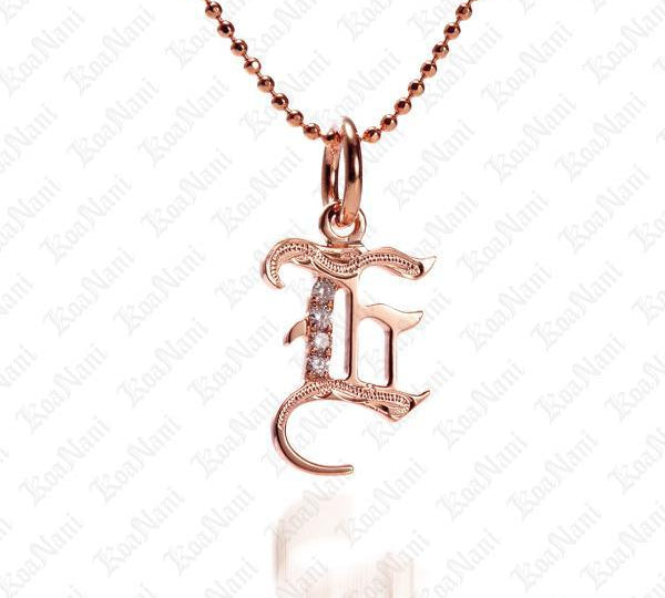 The picture shows a 14K rose gold Koa Nani E initial pendant.