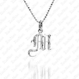 The picture shows a 14K white gold Koa Nani M initial pendant.