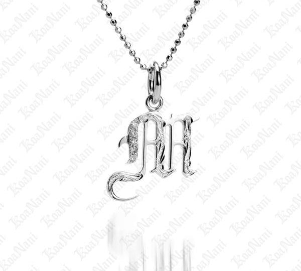 The picture shows a 14K white gold Koa Nani M initial pendant.
