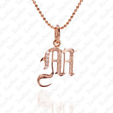 The picture shows a 14K rose gold Koa Nani M initial pendant.